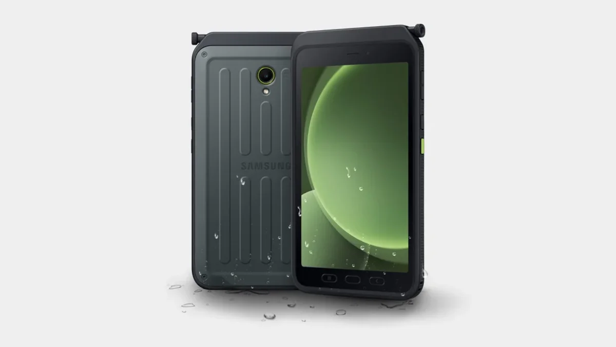 Macro close-up shot of a ruggedized industrial tablet chassis with reinforced corners and metallic alloy textures, glowing blue circuit patterns integrated into the frame, floating abstract data visualization nodes and wireframe analytics i