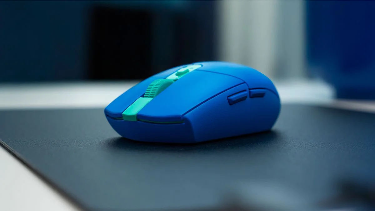 Macro shot of a high-performance wireless computer mouse resting on a sleek dark desk, glowing blue accent light streaks tracing the path of the sensor, abstract data flow particles swirling in the background, cinematic depth of field, prof